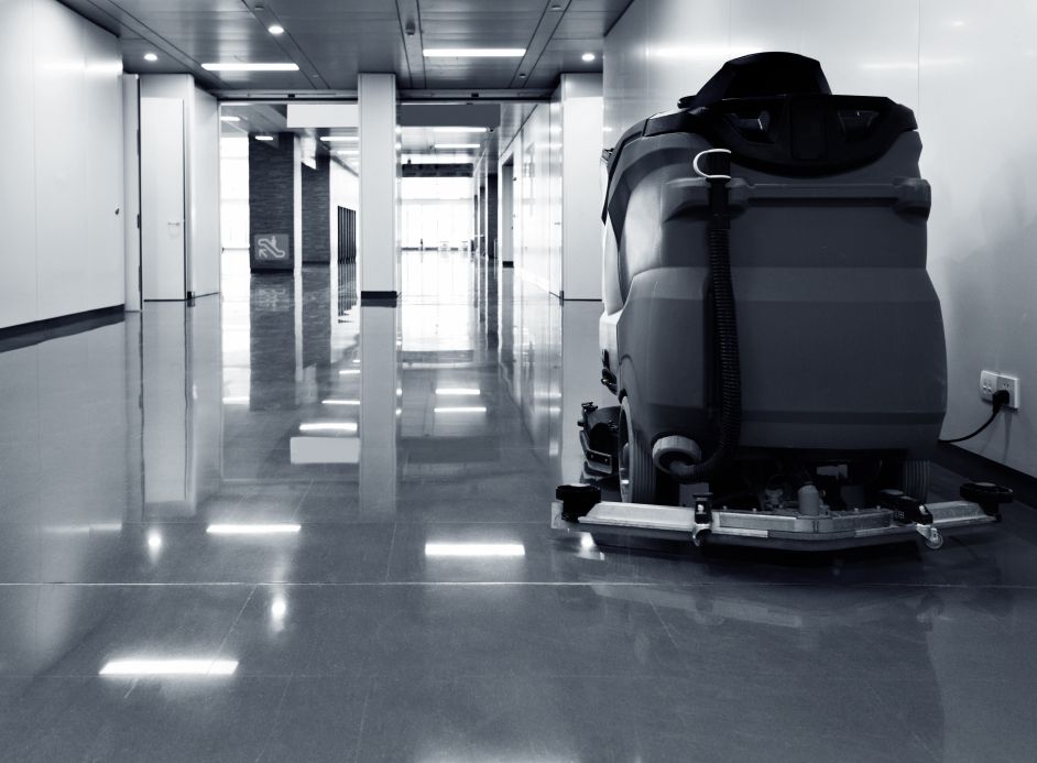 Cleaning machine for floors stands in a long corridor